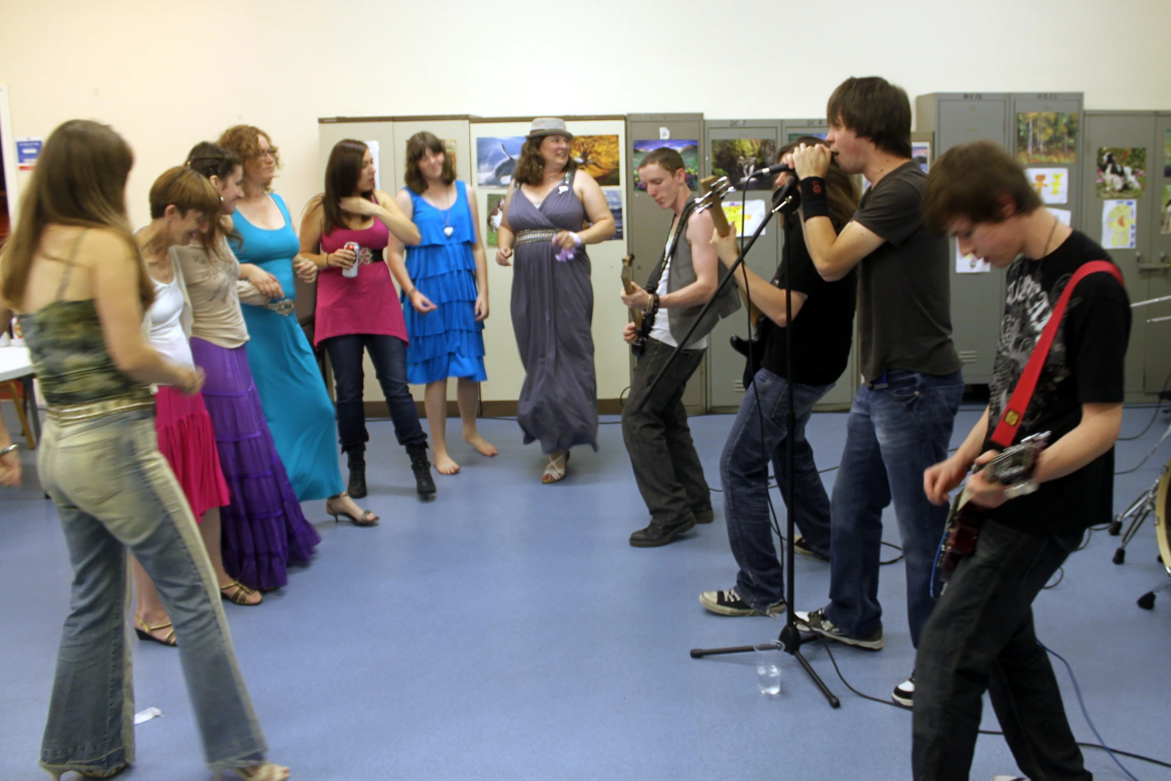 a group of people singing in the band room