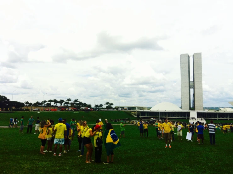 many people are standing around the big building