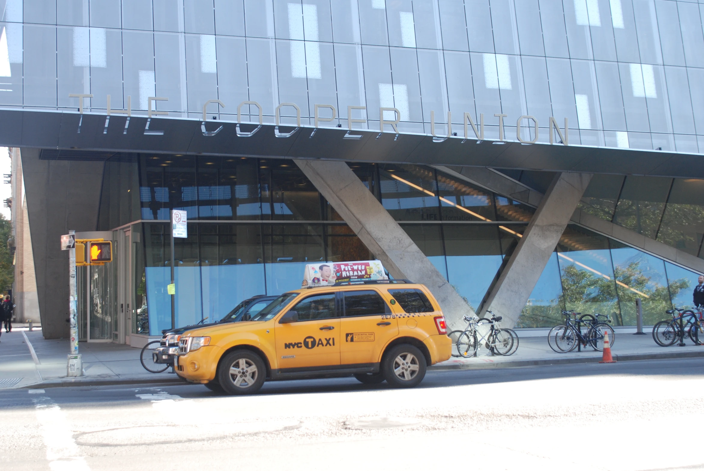 a yellow taxi cab parked in front of a building