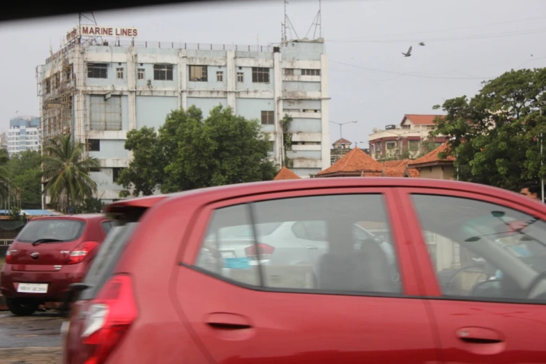 the back of a red car on a city street