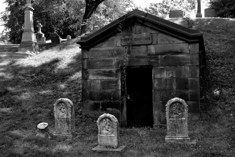 black and white pograph of a small old graveyard with an open door