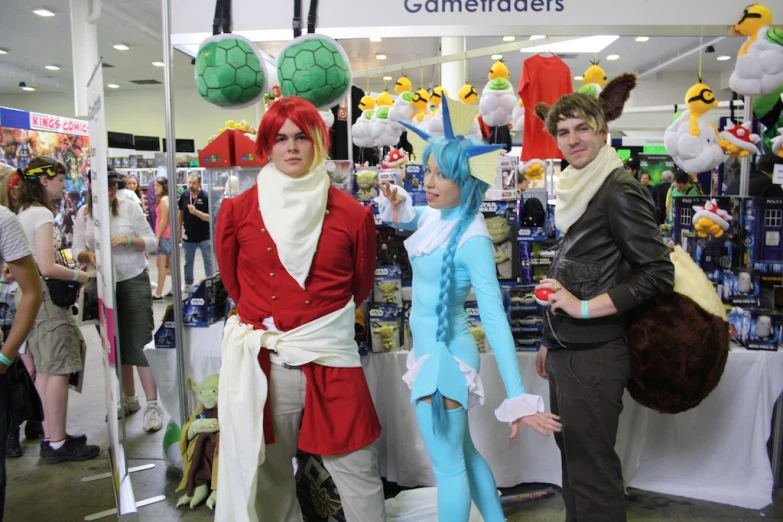 three people wearing costumes and wigs at a booth