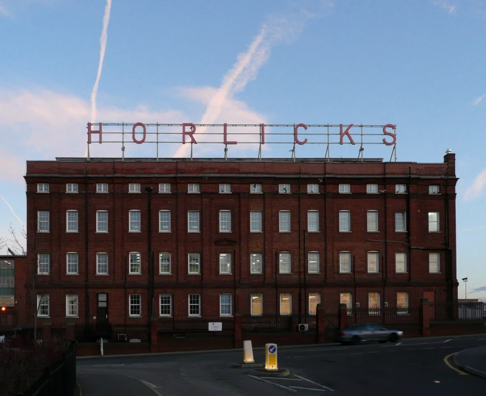 a red brick building with a sign on top of it