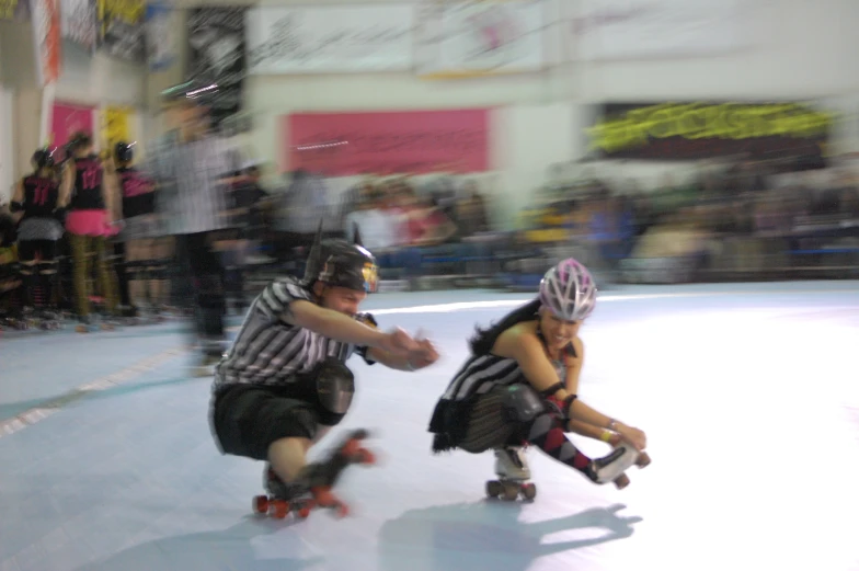 a blurry po of two people on roller skates in front of a crowd