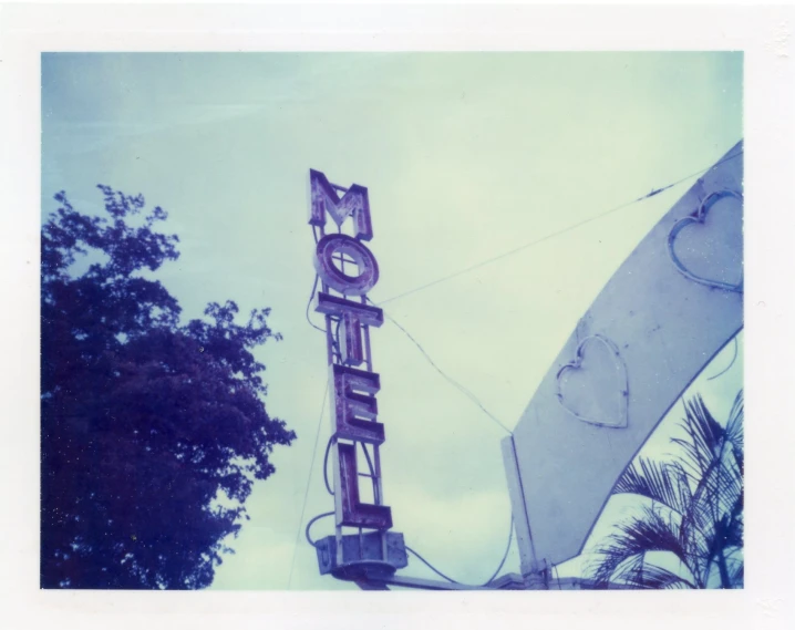 a very large neon el sign on top of a building