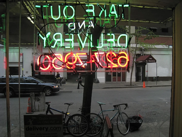neon signs outside a restaurant on a street