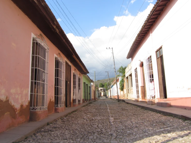 two windows are over the cobblestones on a street