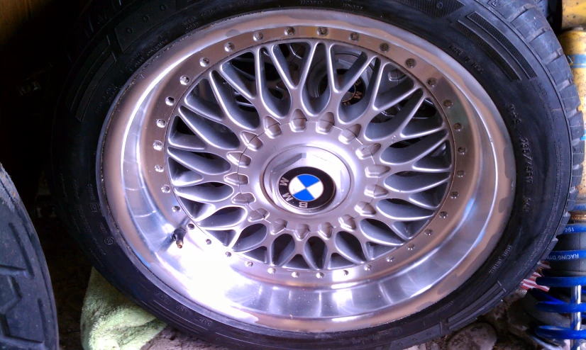 wheel rim with silver rivets sitting on the ground