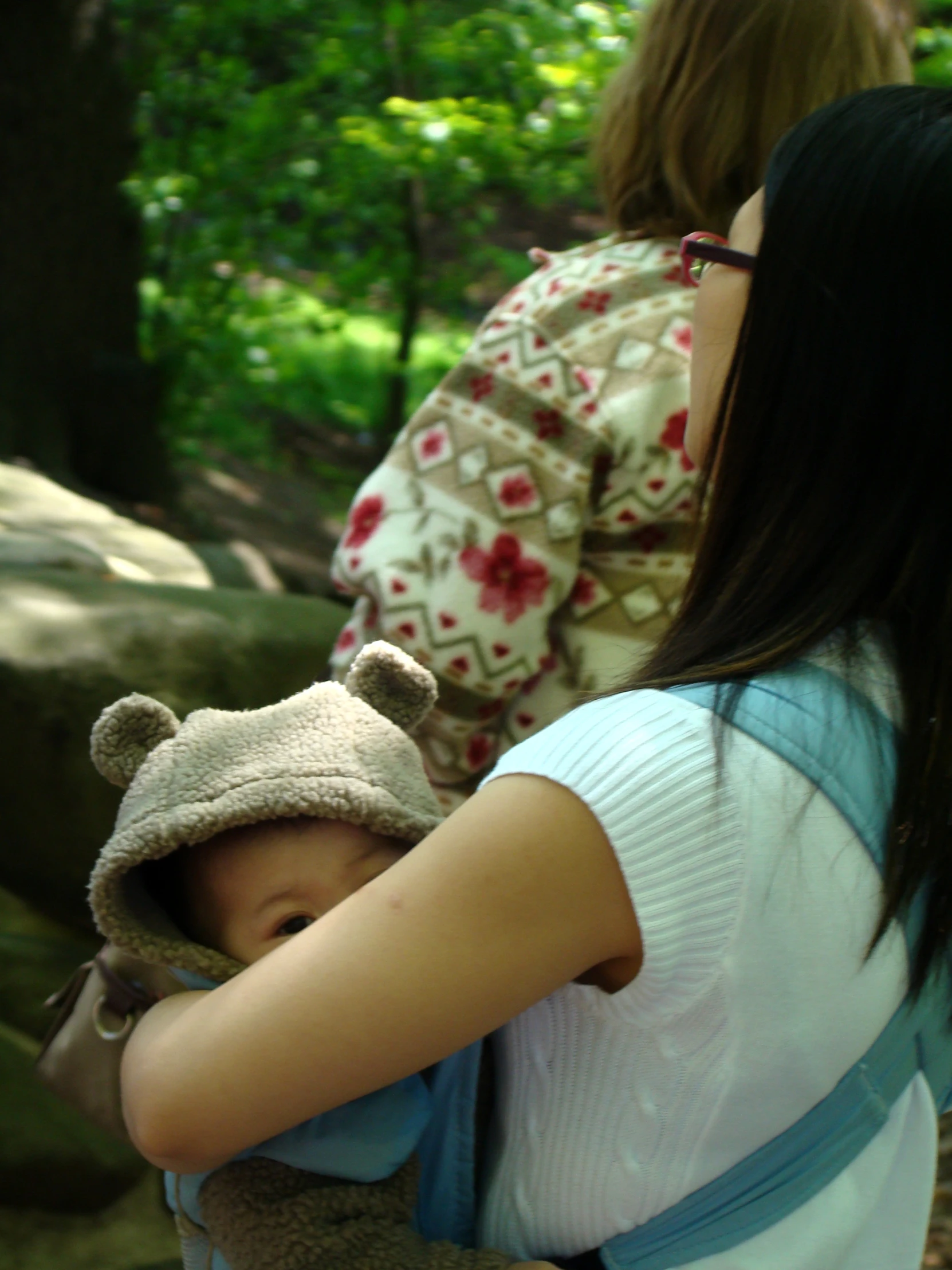 a child in a bear costume and baby in a hat