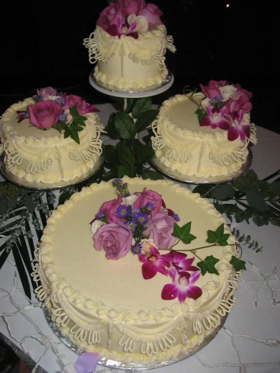 four cake slices and three cakes on a table