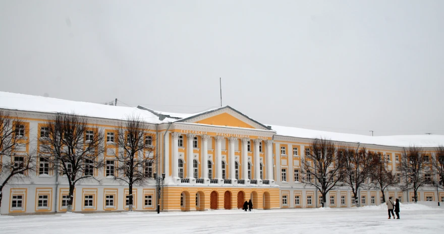 an older building is seen in a snowy scene