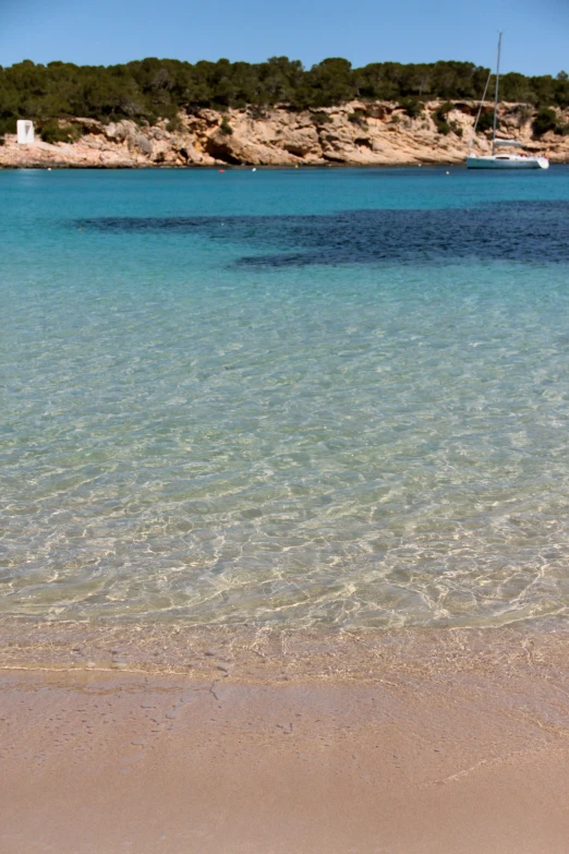 a man in shorts walking into the ocean