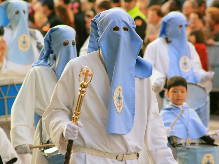 a group of people dressed in blue and white