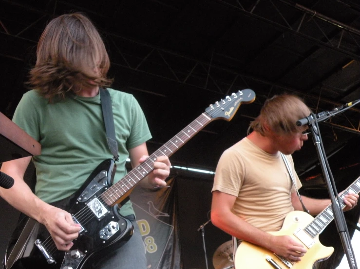 two male musicians are performing on the stage