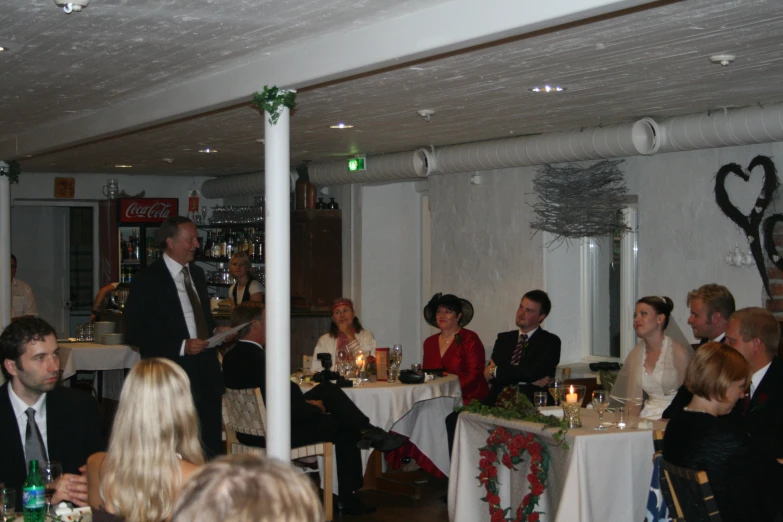 people sitting at tables at an event