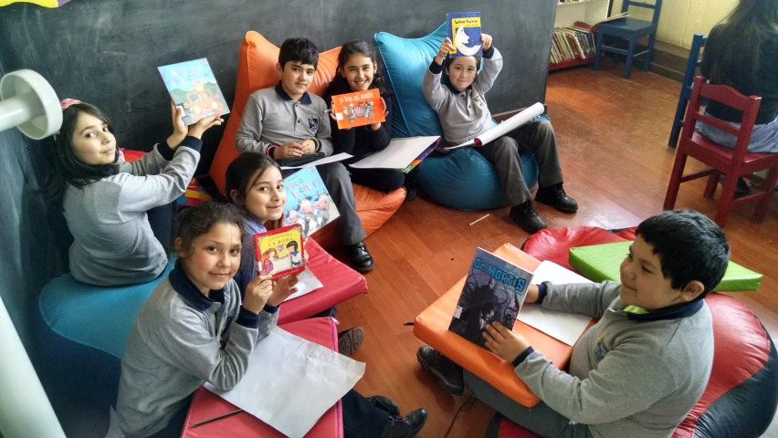 s sit in a circle reading books while holding magazines