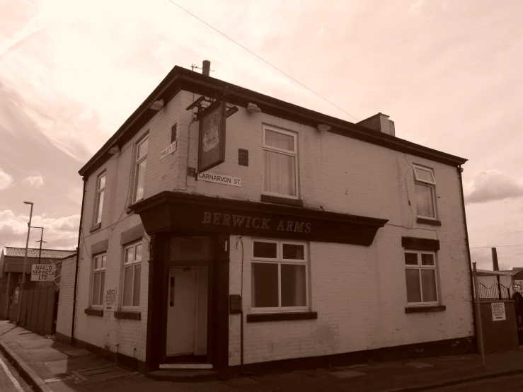 a white brick building with a clock on the front