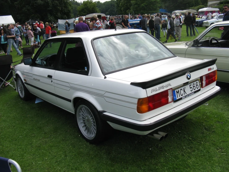 a white bmw with a bmw bumper sticker on it