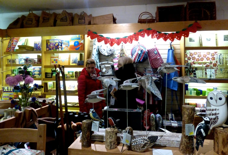 two women standing by some decorative items on display