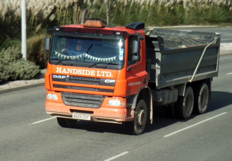 a large truck on a road with its trailer pulled away