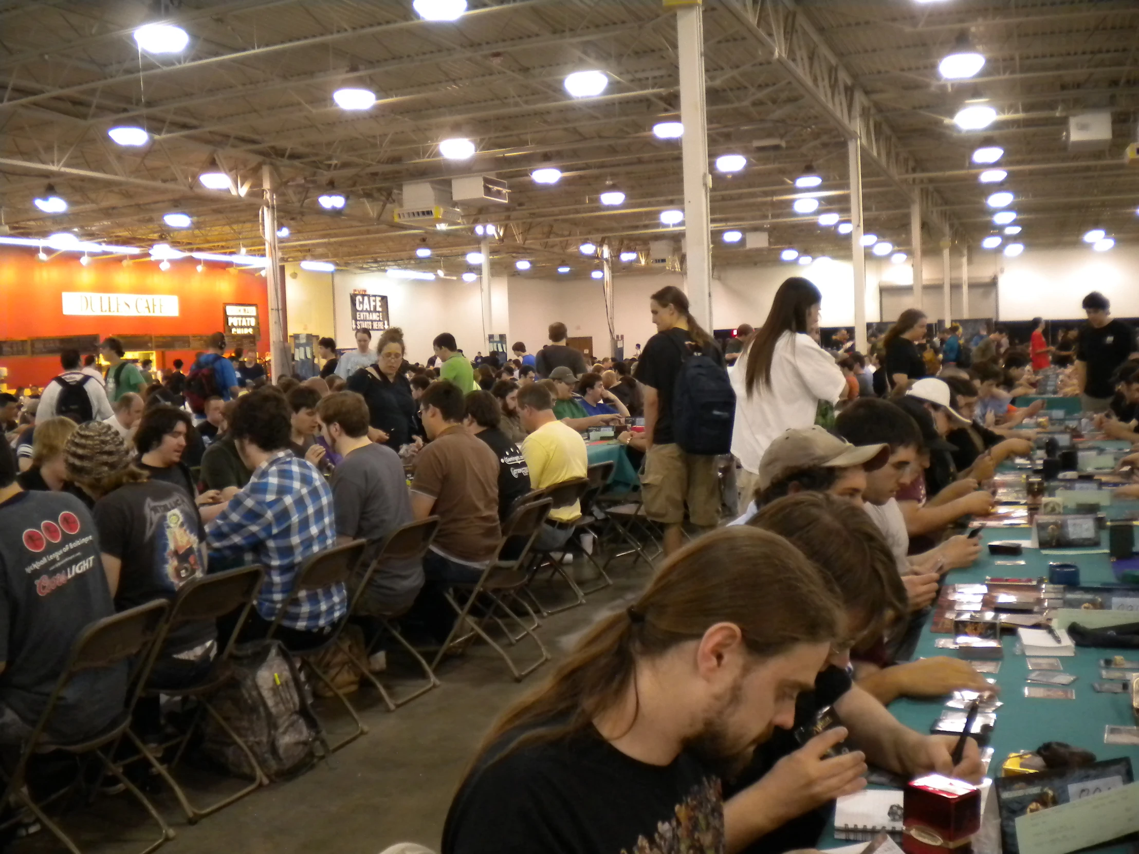 the large dining hall with hundreds of people eating and standing