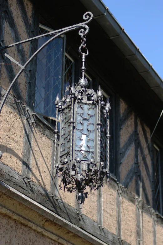 a large metal street light in front of a building