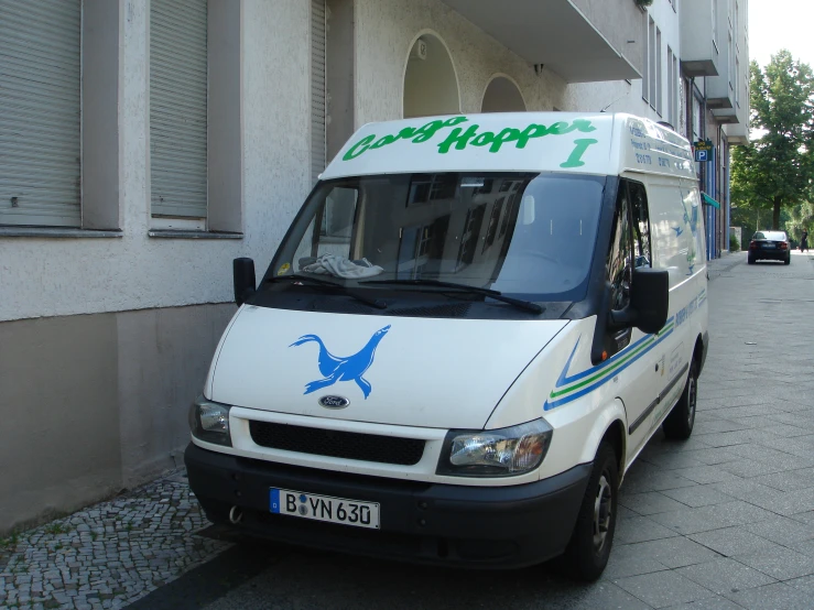 a white van parked next to a building