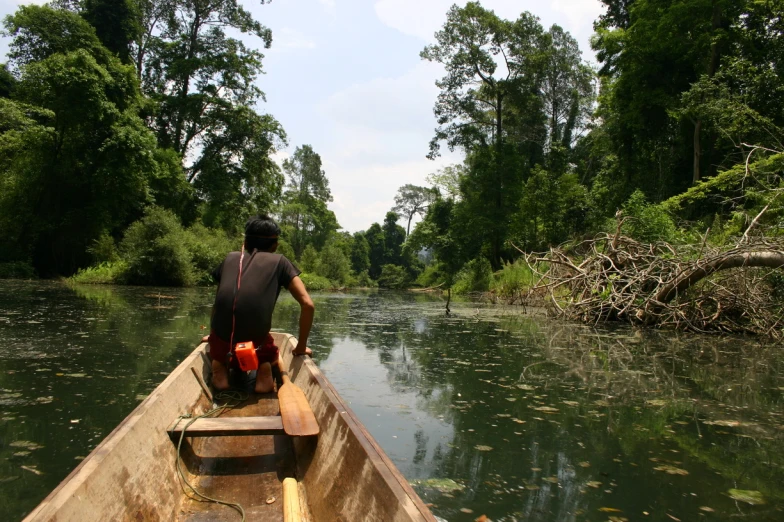 a man in black shirt in a canoe