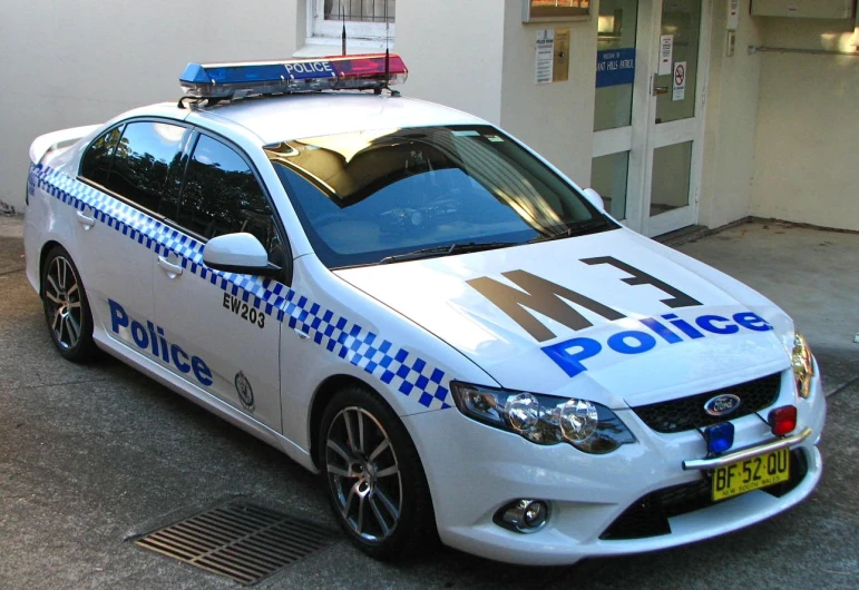 a police car parked next to a building