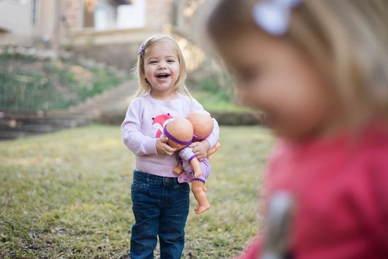 two children play together outside in the yard