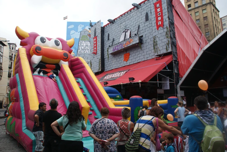 an inflatable bouncy dragon shaped float on the streets