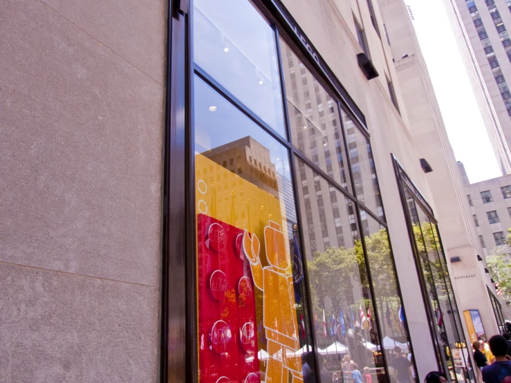 a colorful building is reflected in the window