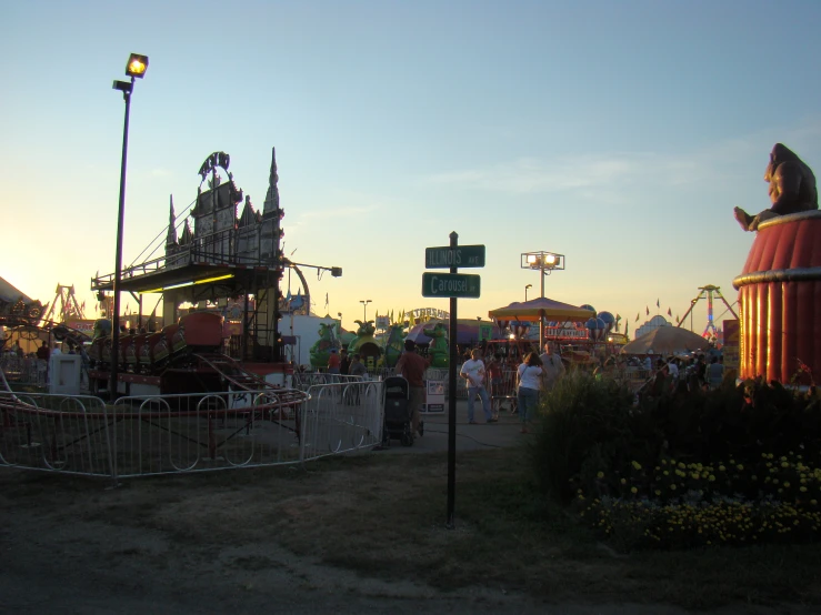 an area with several fair rides at the park