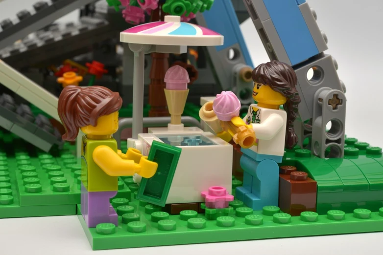 a lego toy and the picture of people eating ice cream on the beach