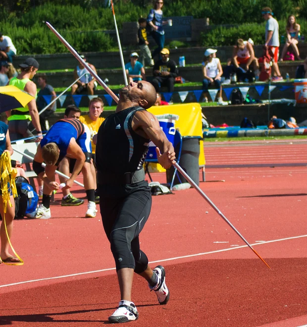 a man is practicing his throwing technique at a competition