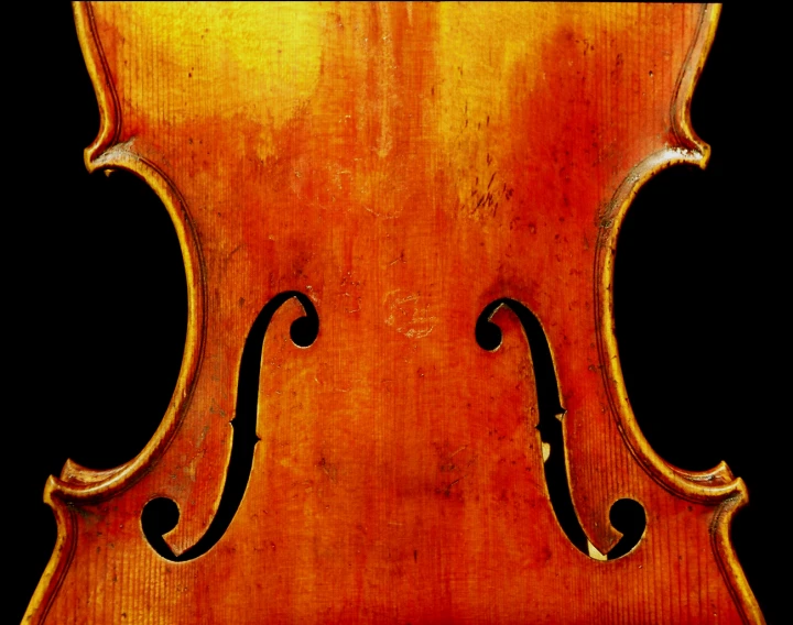 an antique violin that is very old and worn