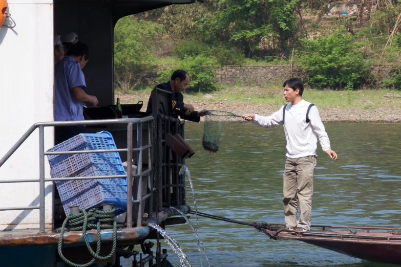 there is a male in the water near a boat