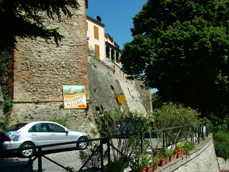 a car is parked near a large building