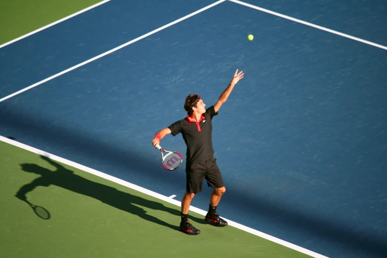 man serving the tennis ball to his teammate