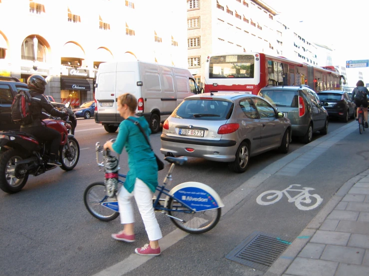 the woman is riding her bike and talking on the phone