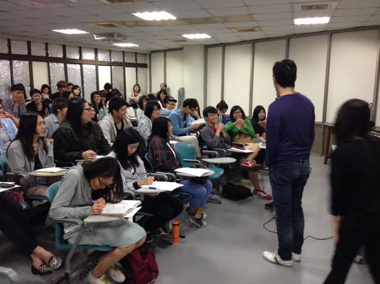 people are in a large classroom with white walls