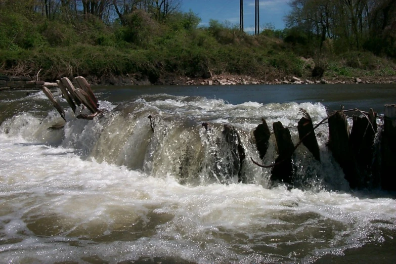 some water flows on to the rocks of a river