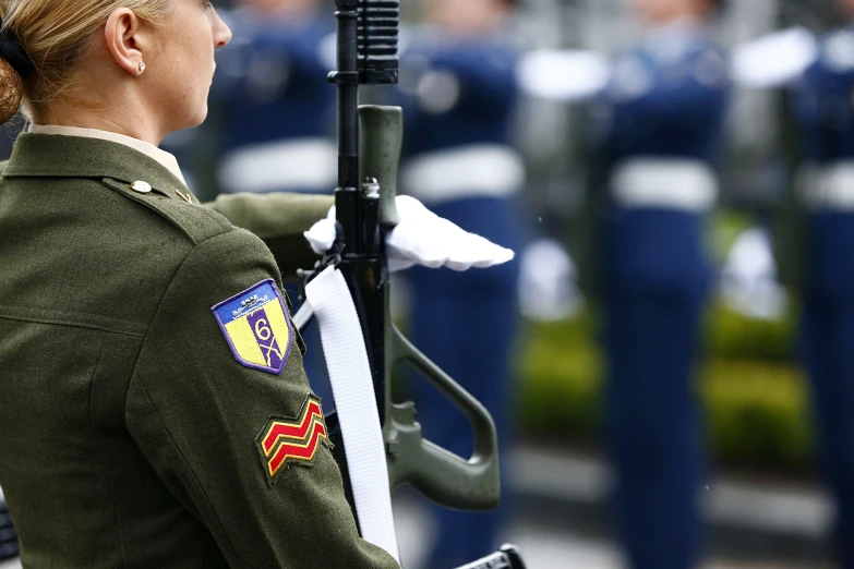 military personnel in uniform stand at attention with the guard