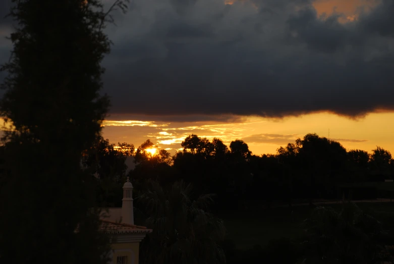 a sunset is seen from the back yard