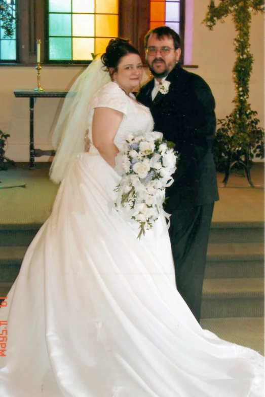 a bride and groom posing for the camera