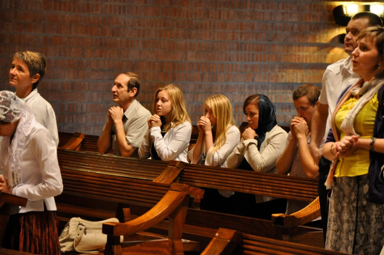 some people sitting in rows in a church