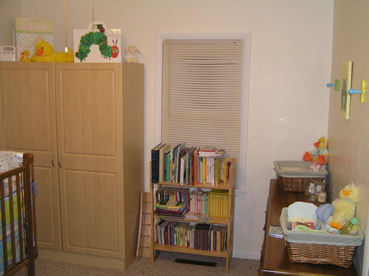 a baby's nursery with a bookshelf and bookcase