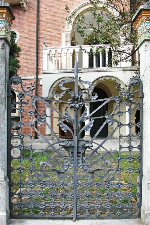 a building with an iron fence with designs in front of it