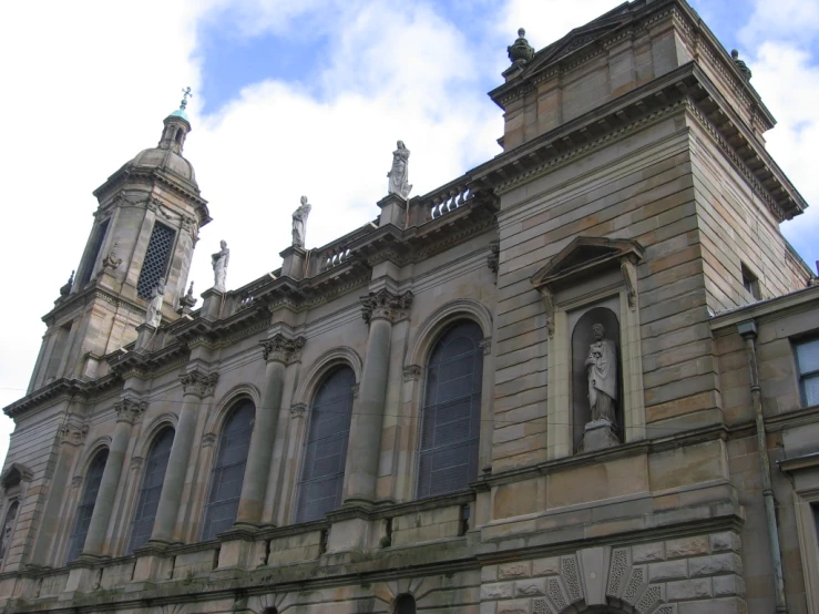 a large brown building with windows and a clock