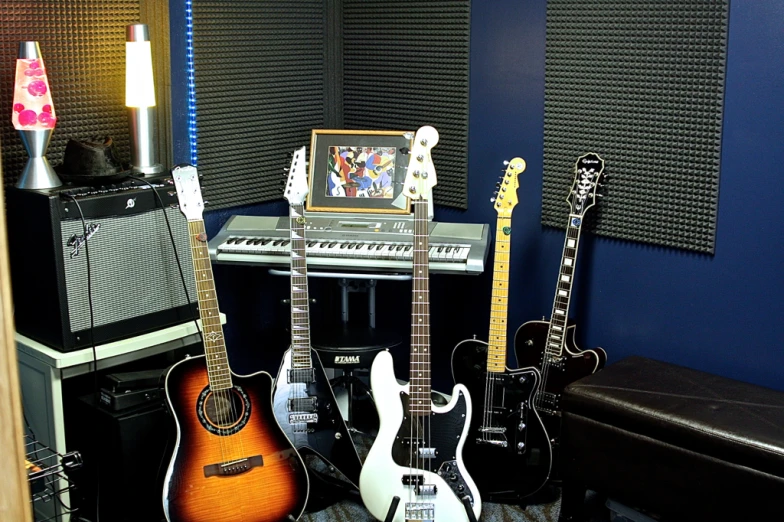 guitars are arranged around a guitar amplifier in the recording studio